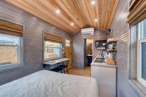 a tiny house with a bed and a kitchen at Stay Portland - Tiny Aztec - Walk to Local Shops & Restaurants in Portland