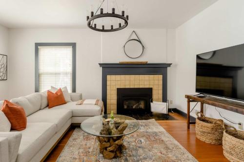 a living room with a couch and a fireplace at Stay Portland - Spacious Restored Craftsmen - Craft Beer & Coffee in Portland