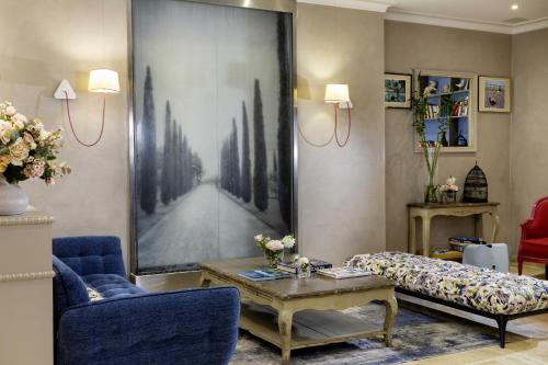a living room with a couch and a coffee table at Hotel Daumesnil-Vincennes in Vincennes
