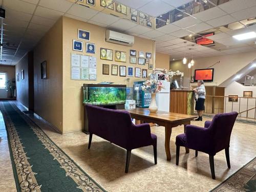 a lobby with a table and a fish tank at Delta in Kyiv