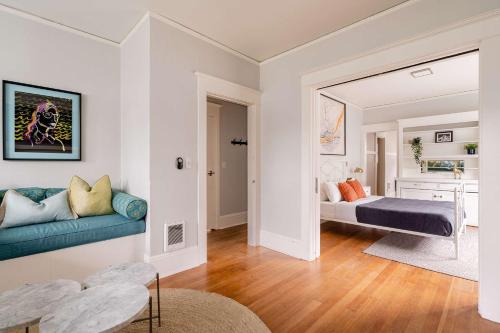 a living room with a couch and a bed at Stay Portland - PDX Art Deco Lounge - Local Eateries, Bars & Shops in Portland