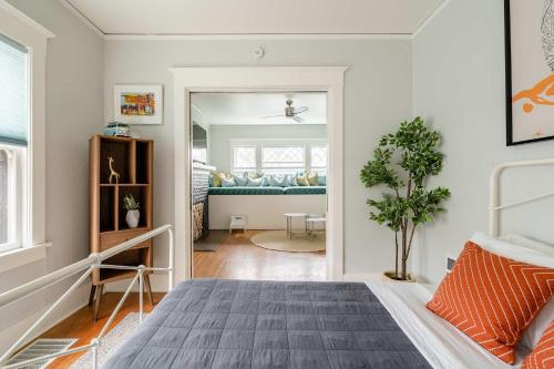 a bedroom with a bed and a living room at Stay Portland - PDX Art Deco Lounge - Local Eateries, Bars & Shops in Portland