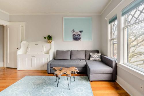 a living room with a gray couch and a table at Stay Portland - Portland Classic - Parks, Eateries & Local Shops in Portland