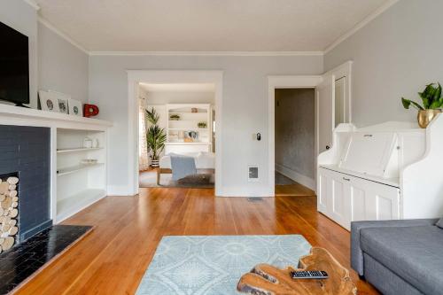 a living room with a couch and a fireplace at Stay Portland - Portland Classic - Parks, Eateries & Local Shops in Portland
