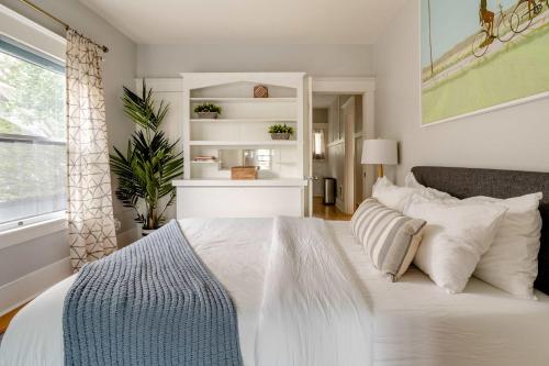 a bedroom with a bed with white sheets and pillows at Stay Portland - Portland Classic - Parks, Eateries & Local Shops in Portland