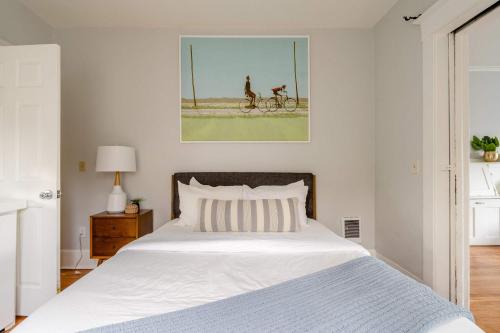 a bedroom with a bed and a painting on the wall at Stay Portland - Portland Classic - Parks, Eateries & Local Shops in Portland