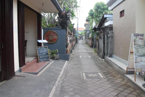 an empty alley with a sign on the side of a building at Betutu Bali Villas in Ubud