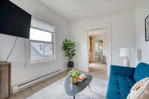 a living room with a blue couch and a window at Stay Portland - Mt Tabor Retreat - Local Eateries - Shops - Bars in Portland