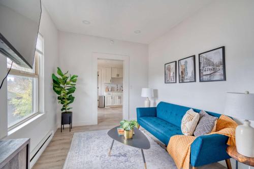 a living room with a blue couch and a table at Stay Portland - Mt Tabor Retreat - Local Eateries - Shops - Bars in Portland