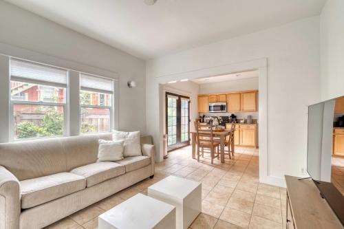 a living room with a couch and a kitchen at Stay Portland - The Sunnyside Cottage, Local Shops & Nightlife in Portland
