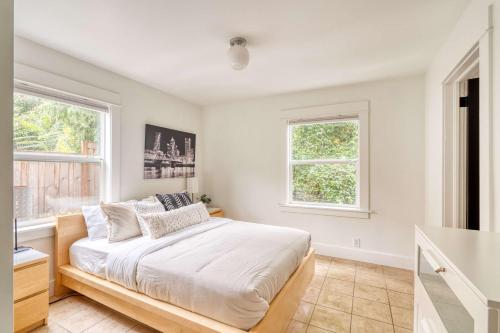 a bedroom with a bed and two windows at Stay Portland - The Sunnyside Cottage, Local Shops & Nightlife in Portland