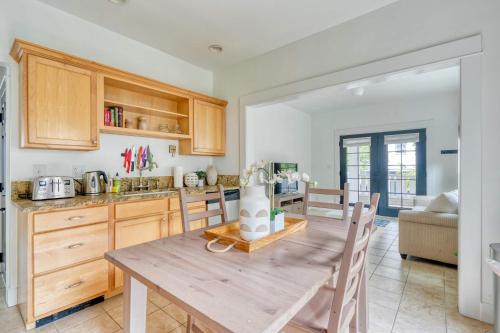 a kitchen with a wooden table and wooden cabinets at Stay Portland - The Sunnyside Cottage, Local Shops & Nightlife in Portland