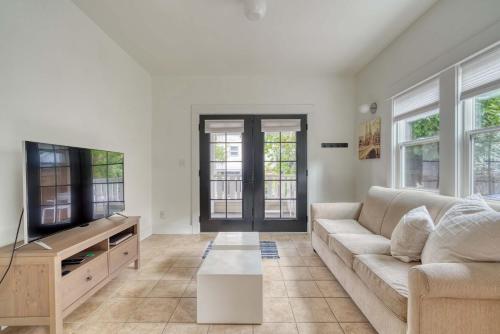 a living room with a couch and a tv at Stay Portland - The Sunnyside Cottage, Local Shops & Nightlife in Portland
