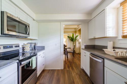 a kitchen with white cabinets and a counter top at Stay Portland - Heart of Portland! Newly Remodeled, 99 Walk Score in Portland