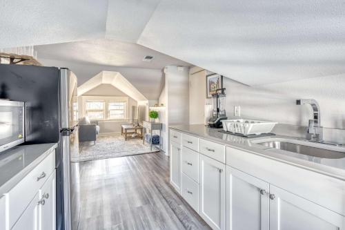 a large kitchen with white cabinets and a sink at Stay Portland - Luxury Portland Gem! 99 Walk Score, New Remodel in Portland