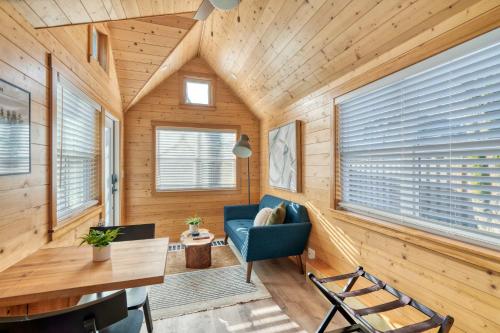 a room with wooden walls and a blue chair and a desk at Stay Portland - Tiny Refuge - Quiet & Cozy in Woodstock