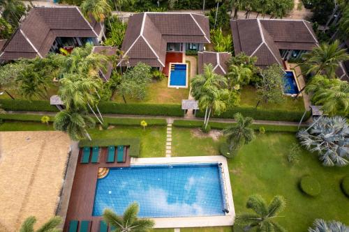 an aerial view of a resort with a swimming pool at Green Garden Villa Hotel in Nai Harn Beach