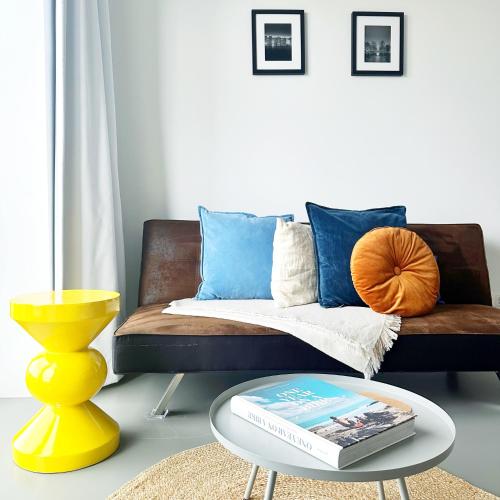 a living room with a couch and a coffee table at Elegant Boutique Apartment 45m2 w Amazing Views in Amsterdam