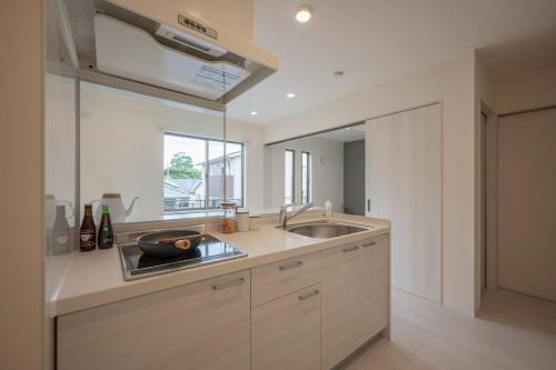 a kitchen with a sink and a counter top at Opt熊本益城 in Mashiki
