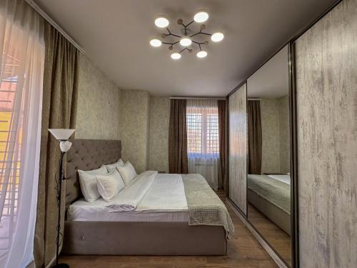 a bedroom with a large bed and a window at White Family House in Tsaghkadzor