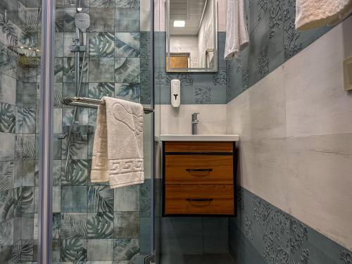 a bathroom with a sink and a shower at White Family House in Tsaghkadzor