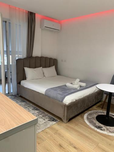a bedroom with a bed and a table at Luxury Apartment Tirana Centre in Tirana