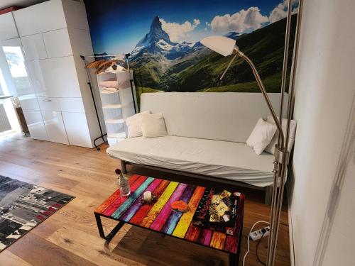 a living room with a couch and a mountain mural at Ferienwohnung Apartment modern, bis 4 Personen, Altstadt fußläufig in Landshut