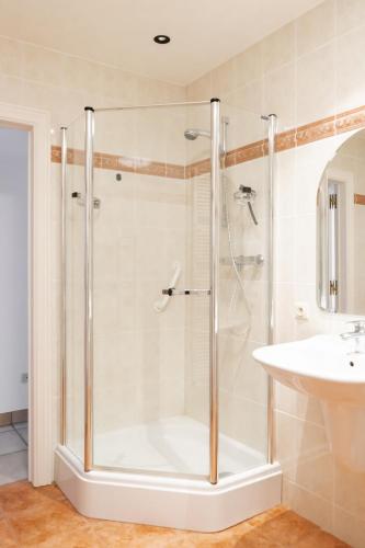 a shower with a glass door in a bathroom at Casa-Vino in Oostkamp