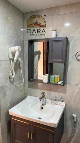 a bathroom with a sink and a mirror at DARA RUM lUXURY CAMP in Wadi Rum