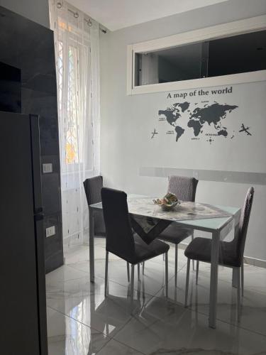 a dining room with a table with chairs and a map of the world at La casa dei sogni in Torre del Greco