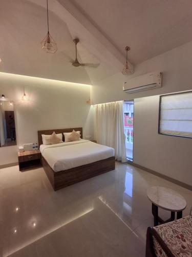 a large bedroom with a bed and a table at Villa with Pool at Sea Horizon Luxurious Villas in Mandrem