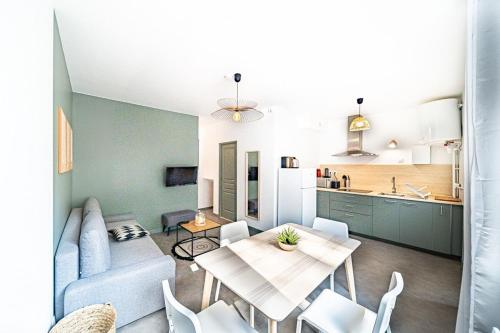 a living room with a couch and a table at Les Amandiers 4 pers- Oullins centre-Lyon in Oullins