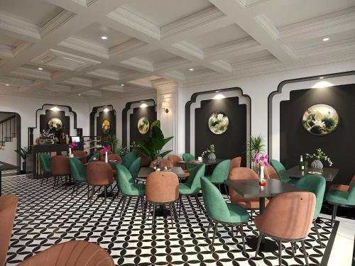 a restaurant with green chairs and tables and mirrors at Light Vesper Premium Hotel & Sky Bar in Ho Chi Minh City