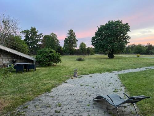 a couple of chairs sitting on a stone path at Kangru Holiday Home in Vanamõisa
