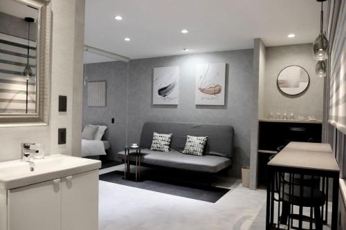 a living room with a couch and a sink at Jasmin Nishikimachi III - Vacation STAY 13079v in Takamatsu