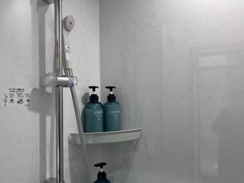 two bottles of soap are sitting on a shelf in a bathroom at Jasmin Jasmin Nishikimachi I - Vacation STAY 11175v in Takamatsu