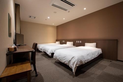 Postel nebo postele na pokoji v ubytování Kur and Hotel Isawa