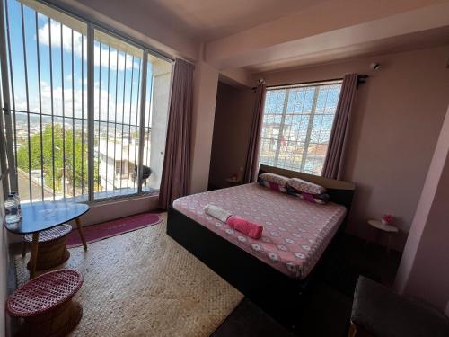 a small room with a bed and a window at GRETZbnb in Shillong