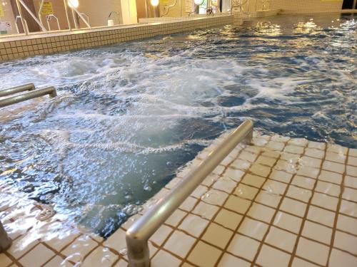 a large swimming pool with water in it at Kur and Hotel Shinshu in Shiojiri