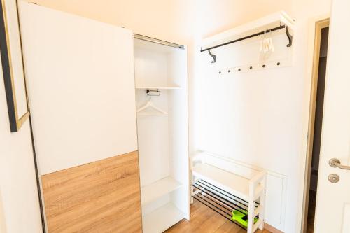 a walk in closet with white cabinets and a mirror at 215 Apartment Wien 4-6 Pers 42m2 in Klagenfurt