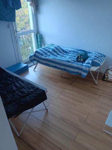 a room with a bed and a wooden floor at Olembe Garden in Avon