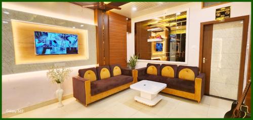 a living room with a couch and a table at SHANTI RESIDENCY - Comfort - Clam The Heart of Varanasi - Near The kashi Vishwanath temple # Best Hotel In Varanasi in Varanasi