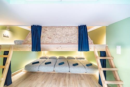 a bunk bed in a room with two bunk beds at Sleep and go - unusual accommodation - Saint Genis Laval in Oullins