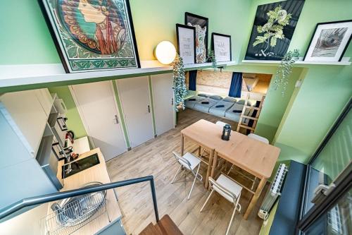 a room with a table and a dining room at Sleep and go - unusual accommodation - Saint Genis Laval in Oullins