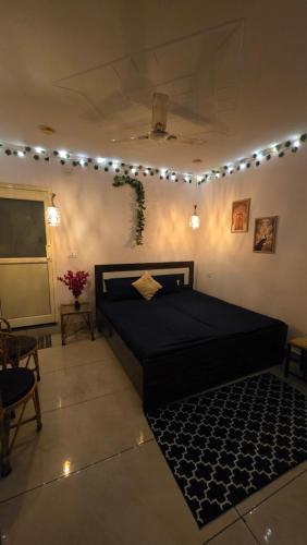 a bedroom with a large black bed with a rug at SAMANI Homestay in Rishīkesh