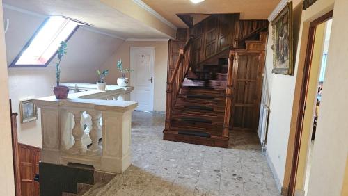 a kitchen with a spiral staircase in a house at Parish Bull Hotel in Kisvárda