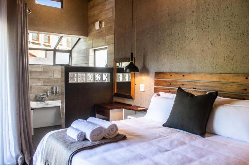 Un dormitorio con una cama con toallas. en High on a Hill, en Clarens