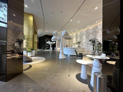 a lobby with two tables and a flower on the wall at Luxury apt in Panama City 2 Rooms 3 Baths office in Panama City