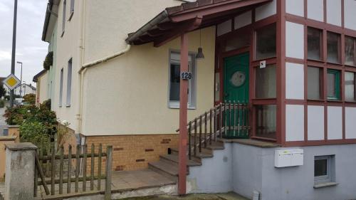 a house with a green door and a porch at ME Apartments Würges 1 2 8 in Bad Camberg