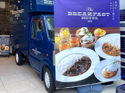 a blue food truck with plates of food on it at The BREAKFAST HOTEL Fukuoka Nakasu in Fukuoka